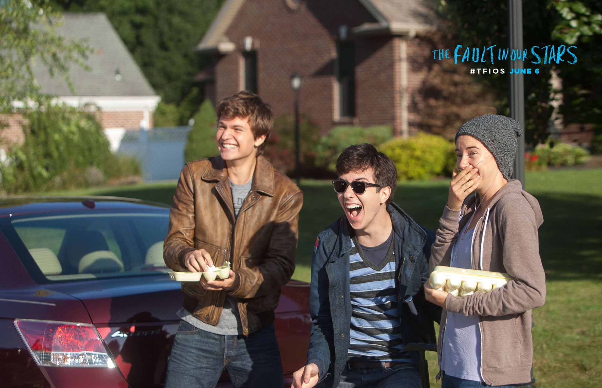 Hazel Green (Shailene Woodley), Isaac (Nat Woolf), and Augustus Waters (Ansel Elgort) throw eggs at a house. (The Fault in Our Stars official website)