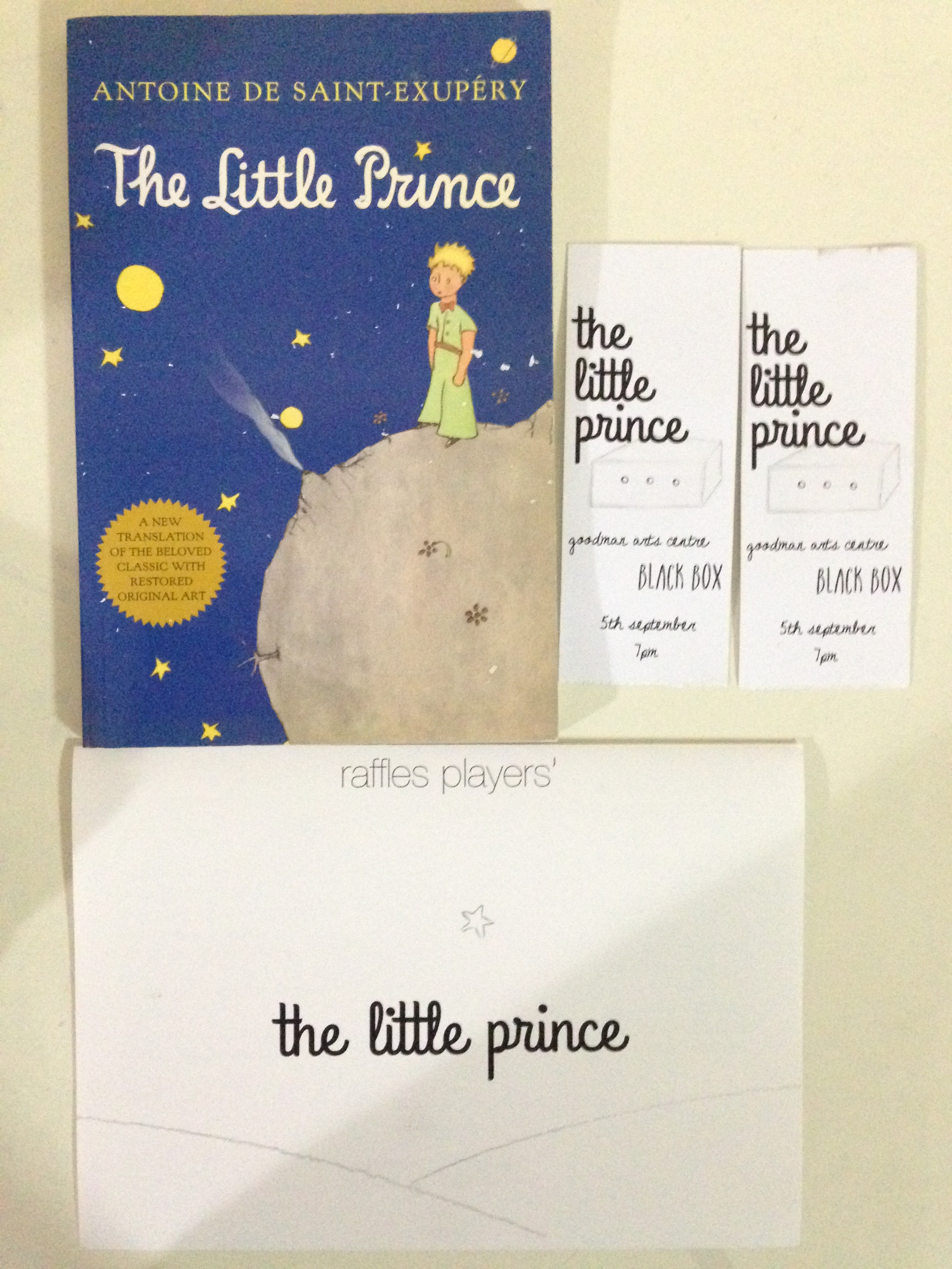 "The Little Prince" book, programme booklet, and tickets.