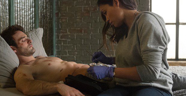 Claire Temple (Rosario Dawson) nurses Matt Murdock in "Daredevil." (Screen Rant)