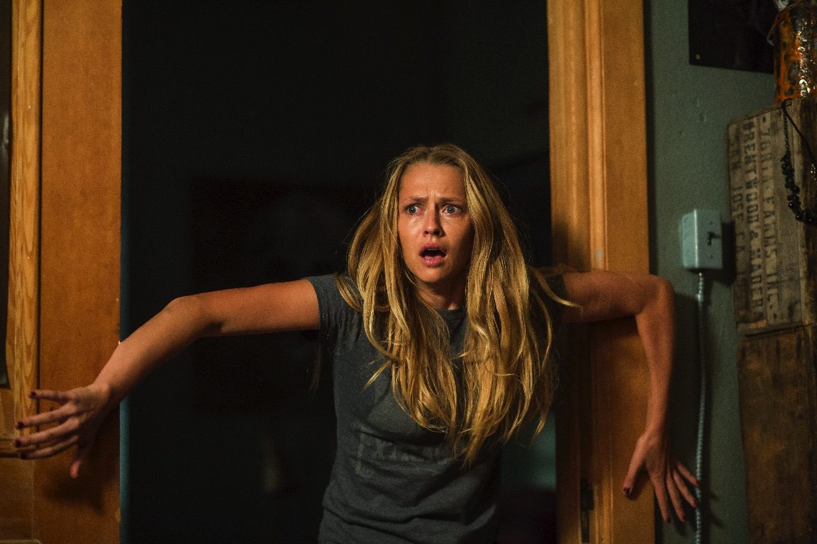 Rebecca (Teresa Palmer) would be doomed if she had hagiophobia in "Lights Out." (Warner Bros Pictures)