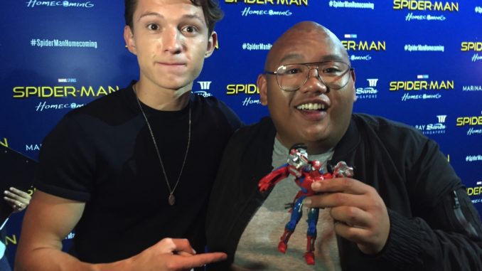 Tom Holland and Jacob Batalon and a Spider-Man Transformer.